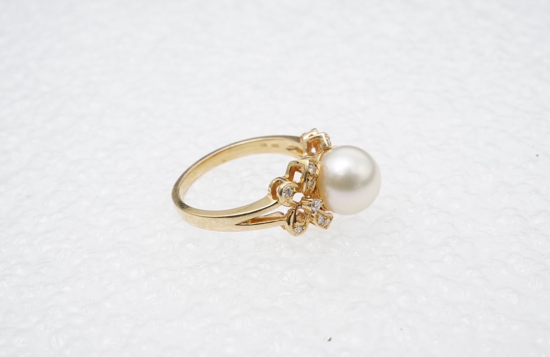 A cultured pearl and diamond ring
